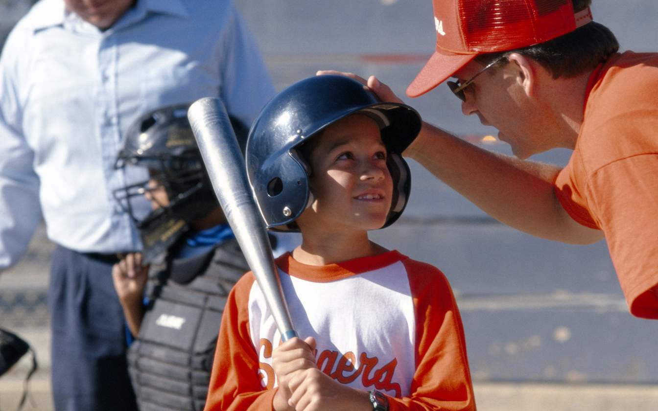 baseball coach speaking with kid